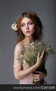 Sentimentality. Redhaired Affectionate Muse with Flowers in Dreams