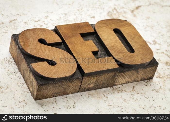 SEO acronym (search engine optimization) - a word in vintage letterpress wood type on a ceramic tile background