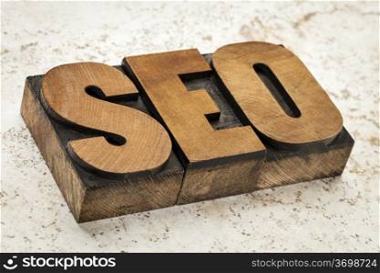 SEO acronym (search engine optimization) - a word in vintage letterpress wood type on a ceramic tile background
