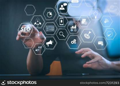 Seo Optimization for website with mobile website and Landing page virtual diagram.businessman wearing virtual reality goggles in modern office with Smartphone using with VR headset with screen icon diagram