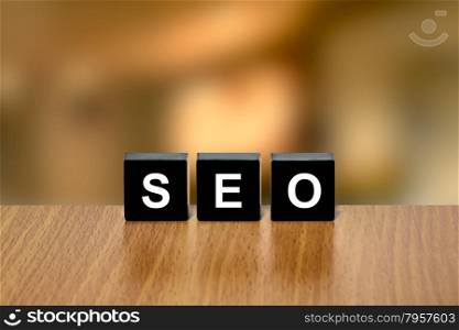 SEO or Search engine optimization on black block with blurred background