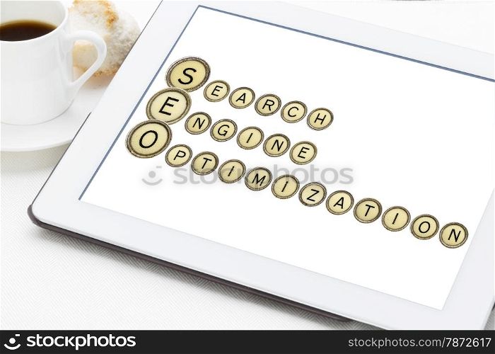 SEO (search engine optimization) acronym explained with old typewriter keys on a digital tablet