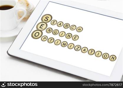 SEO (search engine optimization) acronym explained with old typewriter keys on a digital tablet
