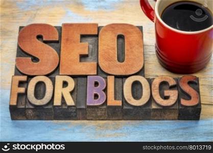 SEO (search engine optimization) for blogs - word abstract in vintage letterpress wood type printing blocks stained by color inks with a cup of coffee