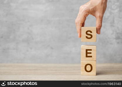 SEO (Search Engine Optimization) text wooden cube blocks on table background. Idea, Strategy, advertising, marketing, Keyword and Content concept