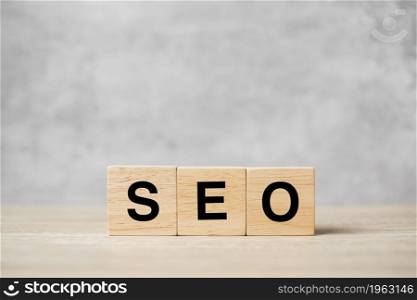 SEO (Search Engine Optimization) text wooden cube blocks on table background. Idea, Strategy, advertising, marketing, Keyword and Content concept