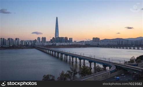 Seoul cityscape with Han River at sunset in South Korea.