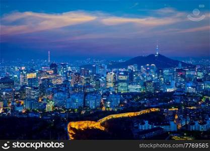 Seoul downtown cityscape illuminated with lights and Namsan Seoul Tower in the evening view from Inwang mountain. Seoul, South Korea.. Seoul skyline in the night, South Korea.