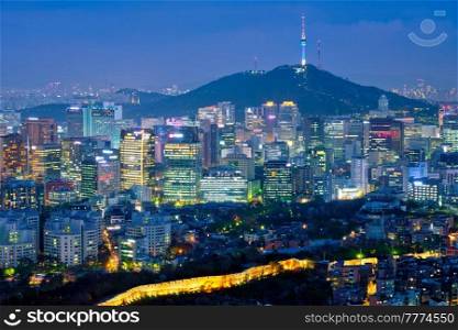 Seoul downtown cityscape illuminated with lights and Namsan Seoul Tower in the evening view from Inwang mountain. Seoul, South Korea.. Seoul skyline in the night, South Korea.
