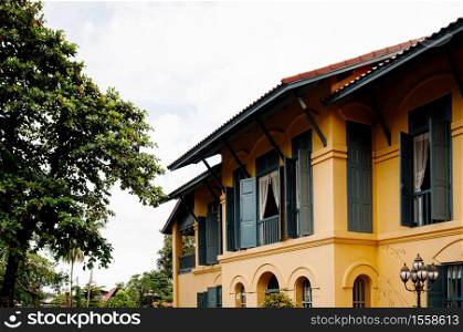 SEP 14, 2012 Nakhon Phanom, Thailand - Nakhon Phanom vintage old Governor house with simple Asian - French colonial architecture style and big tree - Thailand