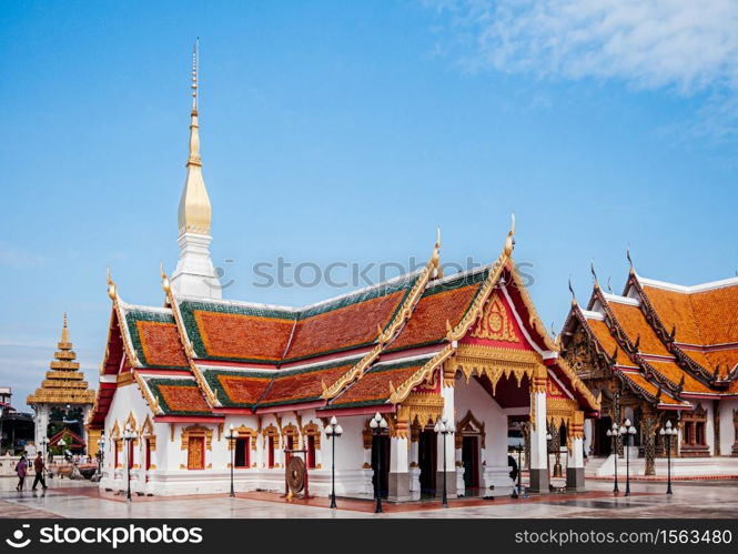 SEP 16, 2012 Sakon Nakhon, Thailand - Grand ancient pagoda and buddha hall of Wat phra that choeng chum, most sacred temple with tourists.