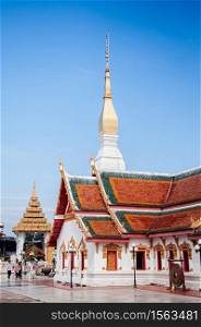 SEP 16, 2012 Sakon Nakhon, Thailand - Grand ancient pagoda and buddha hall of Wat phra that choeng chum, most sacred temple with tourists.