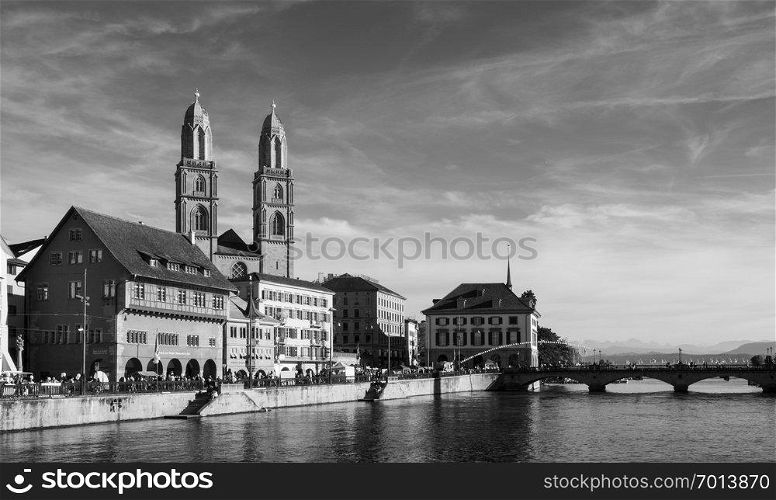 SEP 22, 2013 Zurich, Switzerland - Beautiful old vintage buildings of Grossmunster cathedral and medieval buildings by the Limmat river in Zurich Old town Altstadt area