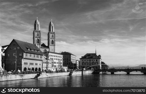 SEP 22, 2013 Zurich, Switzerland - Beautiful old vintage buildings of Grossmunster cathedral and medieval buildings by the Limmat river in Zurich Old town Altstadt area
