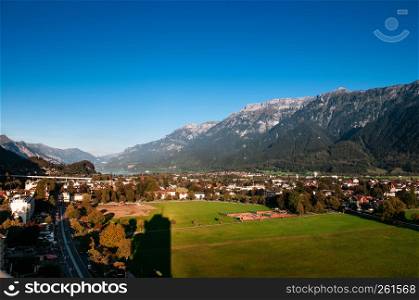 SEP 25, 2013 Interlaken, Switzerland - Evening scene aerial view cityscape and Swiss Alps of Interlaken, famous town for tourists