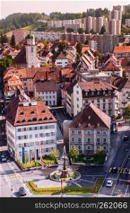 SEP 26, 2013 Neuchatel, Switzerland - Colourful old vintage building aerial view of La Chaux de Fonds city and Monumental fountain, the most important centre of the Swiss watch making industry