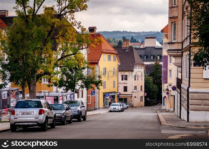 SEP 26, 2013 Neuchatel, Switzerland - Colourful old vintage building and street in La Chaux de Fonds, the most important centre of the Swiss watch making industry