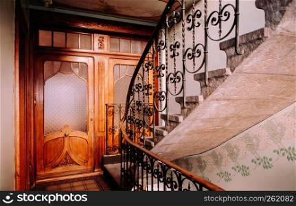 SEP 26, 2013 Neuchatel, Switzerland - Colourful old vintage stairway and wooden door of old building in La Chaux de Fonds, the most important centre of the Swiss watch making industry