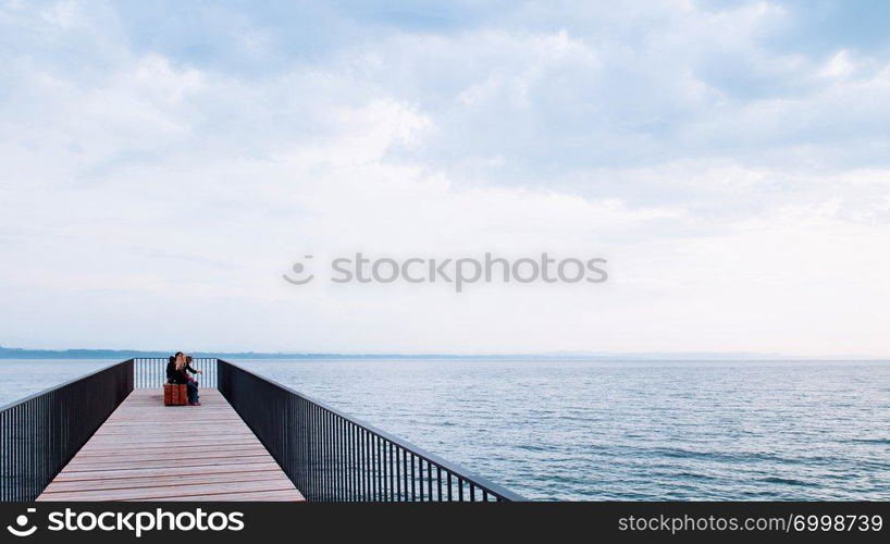 SEP 26, 2013 Neuchatel, Switzerland - Modern architecture bridge of La Passerelle de l’Utopie panoramic terrace Esplanade at lake Neuchatel on cloudy day