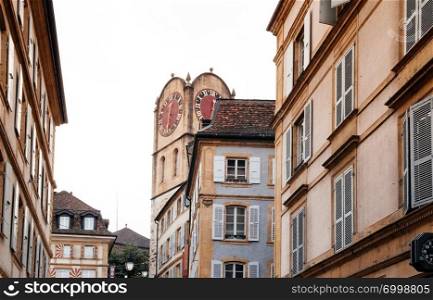 SEP 26, 2013 Neuchatel, Switzerland - Old ancient famous Diesse Tower clock tower among old buildings in Medieval ancient town of Neuchatel