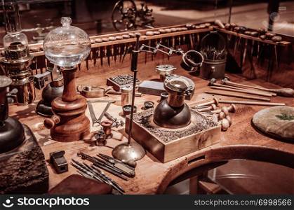 SEP 26, 2013 Neuchatel, Switzerland - old vintage antique Old antique wooden clockmaker table with tools at International Clock-Making Museum of La Chaux de Fonds , the most important centre of the Swiss watch making industry