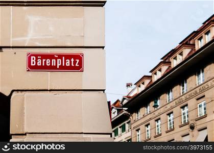SEP 27, 2013 Bern, Switzerland - Bareenpaltz street or square area sign on concrete building wall in Old town of Bern with old building in background