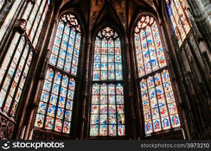 SEP 27, 2013 Bern, Switzerland - Extraordinary beautiful stained glass window telling Jesus Christ story of Evangelical Church or Berne Munster, Gothic style architecture buildings