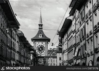 SEP 28, 2013 Bern, Switzerland - Old vintage street scene under sunlight of astronomical Zytglogge clock tower. Famous old town area attraction