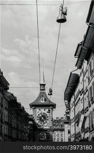 SEP 28, 2013 Bern, Switzerland - Old vintage street scene under sunlight of astronomical Zytglogge clock tower. Famous old town area attraction