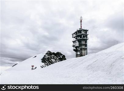 SEP 29, 2013 Engelberg, Switzerland - Snow plain with Titlis Cliff walk tower at glacier park on Titlis mountain peak , famous tourist attraction on Swiss alps.