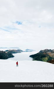 SEP 29, 2013 Engelberg, Switzerland - Tourists walking enjoy wide view of snow slope over cloud and Mountain valley of mount Titlis, famous tourist attraction on Swiss alps.