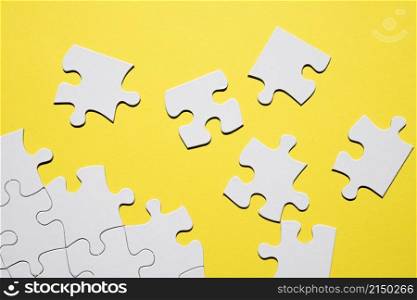 separate white puzzle piece yellow backdrop