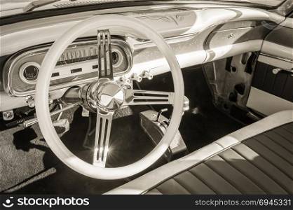 sepia toned vintage car interior and steering wheel
