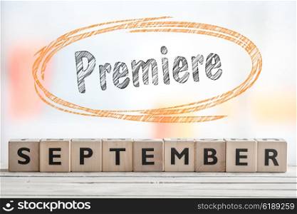 September premiere event sign on a wooden stage