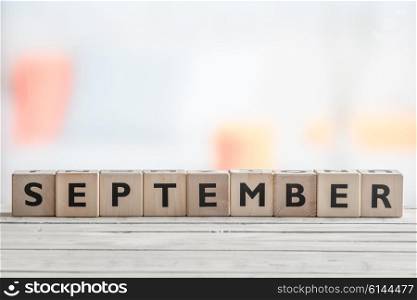 September sign on a wooden table in a living room