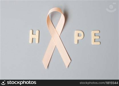 September Uterine Cancer Awareness month, Peach Ribbon for supporting people living and illness. Healthcare and World cancer day concept