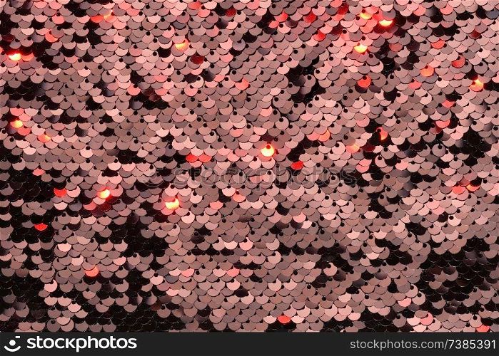 Sequin fabric background. Close-up shot of glittery black sequins texture reflecting red light. Sequin fabric background