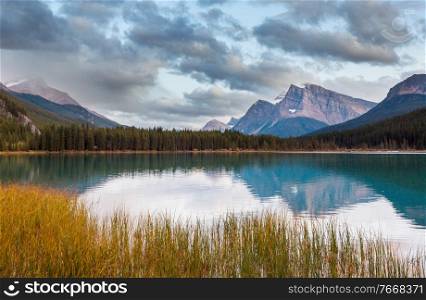 Serene scene by the mountain lake in Canada at sunset