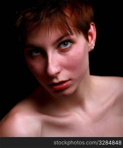serenity - face of pretty redhead girl with blank expression ( dark key studio shot)