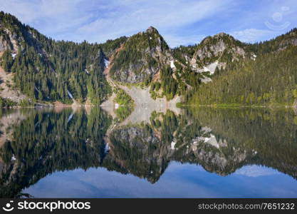 Serenity lake in the mountains in summer season. Beautiful natural landscapes.