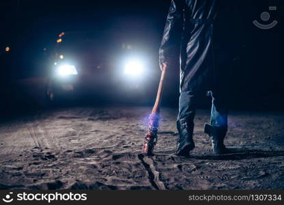 Serial maniac hand with bloody baseball bat closeup, car light at the night on background. Horror, bloody murderer. Maniac hand with bloody baseball bat closeup