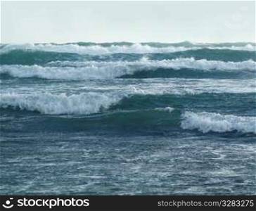 Series of powerful coastal waves crashing to shore.