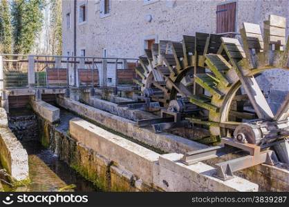Series of three wheeled wooden mill renovated
