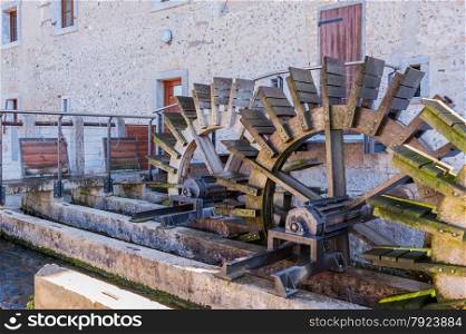 Series of three wheeled wooden mill renovated