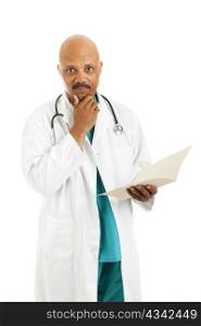 Serious african-american doctor considers treatment options while reviewing a patient&rsquo;s medical chart. Isolated on white.
