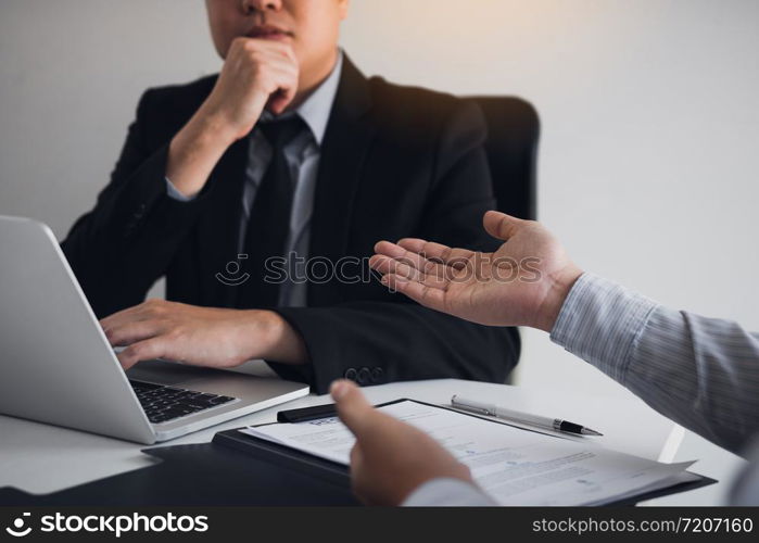 Serious asian businessman important conversation with male employee are reviewing resume documents.