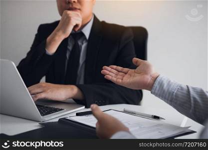 Serious asian businessman important conversation with male employee are reviewing resume documents.