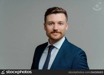 Serious bearded male manager in formal attire poses against grey background. Handsome employer prepared for business meeting. Job concept.