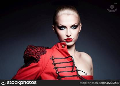 serious blonde woman in red jacket