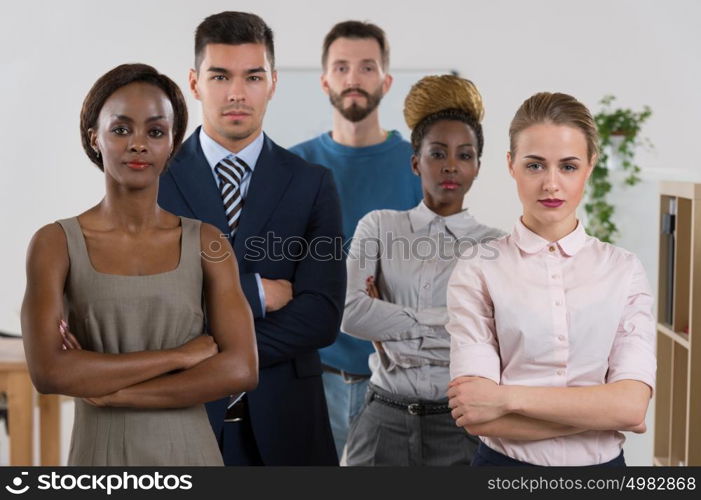 Serious business team standing together at office